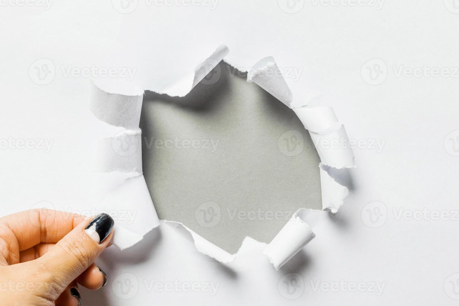 Hole in the paper with torn sides photo