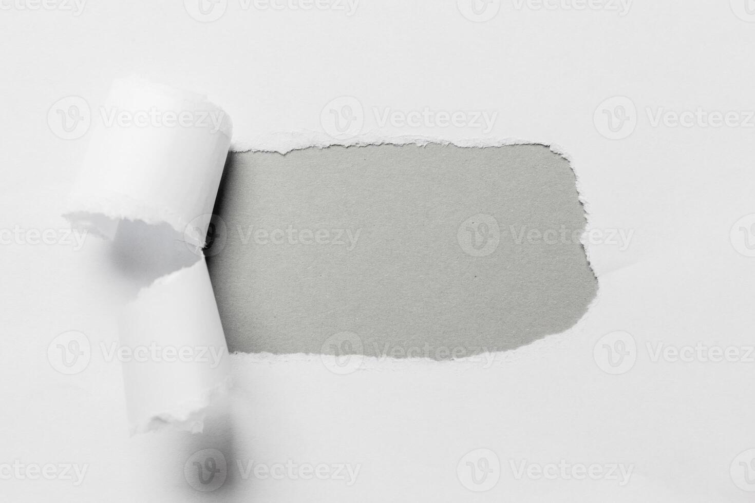 Hole in the paper with torn sides photo