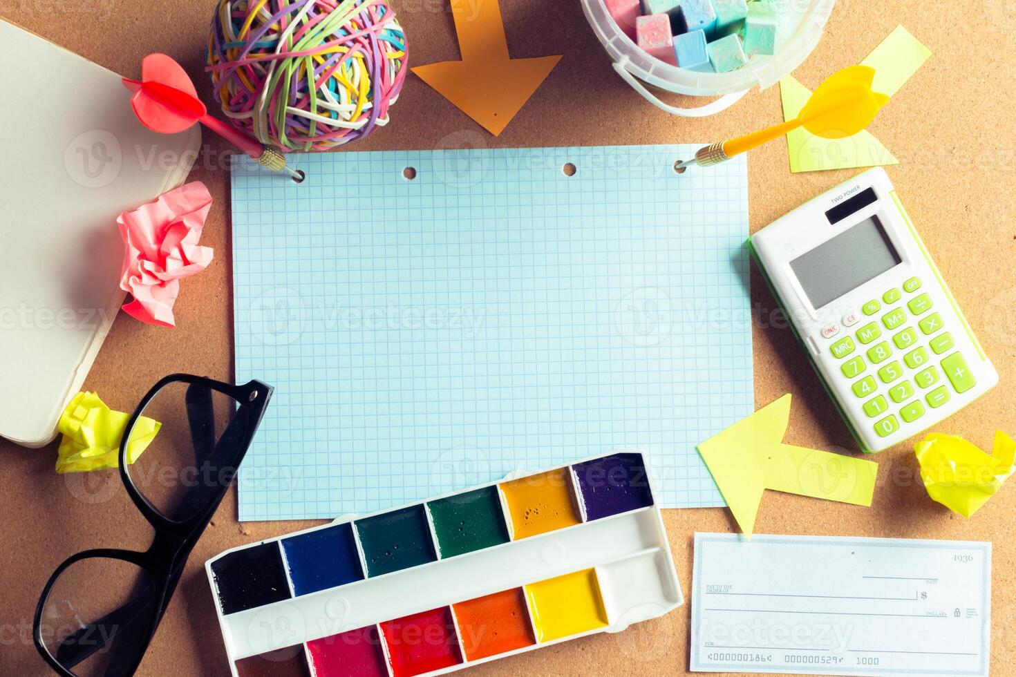 Desk of an artist with lots of stationery objects photo