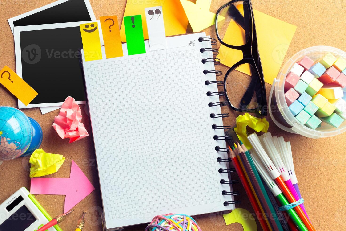Desk of an artist with lots of stationery objects photo