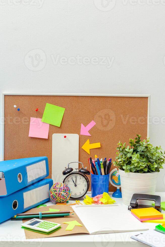 Work place of a creative person with a variety of colorful stationery objects photo