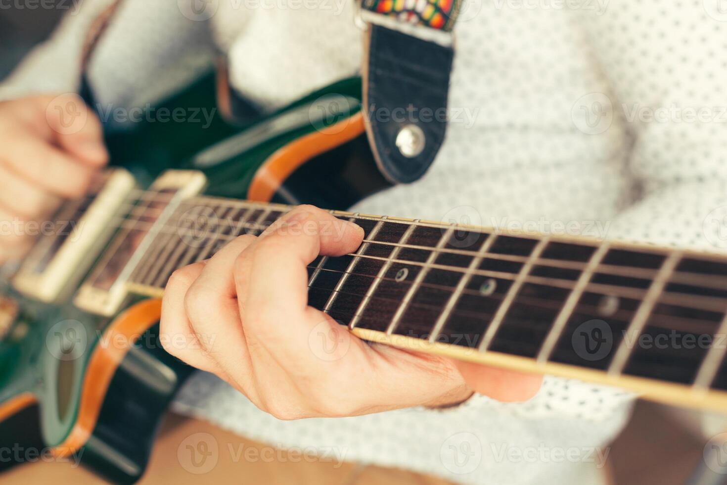 man playing electric guitar photo