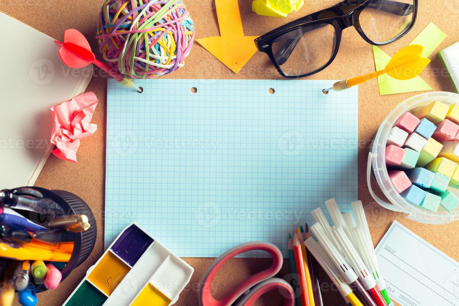 Desk of an artist with lots of stationery objects photo