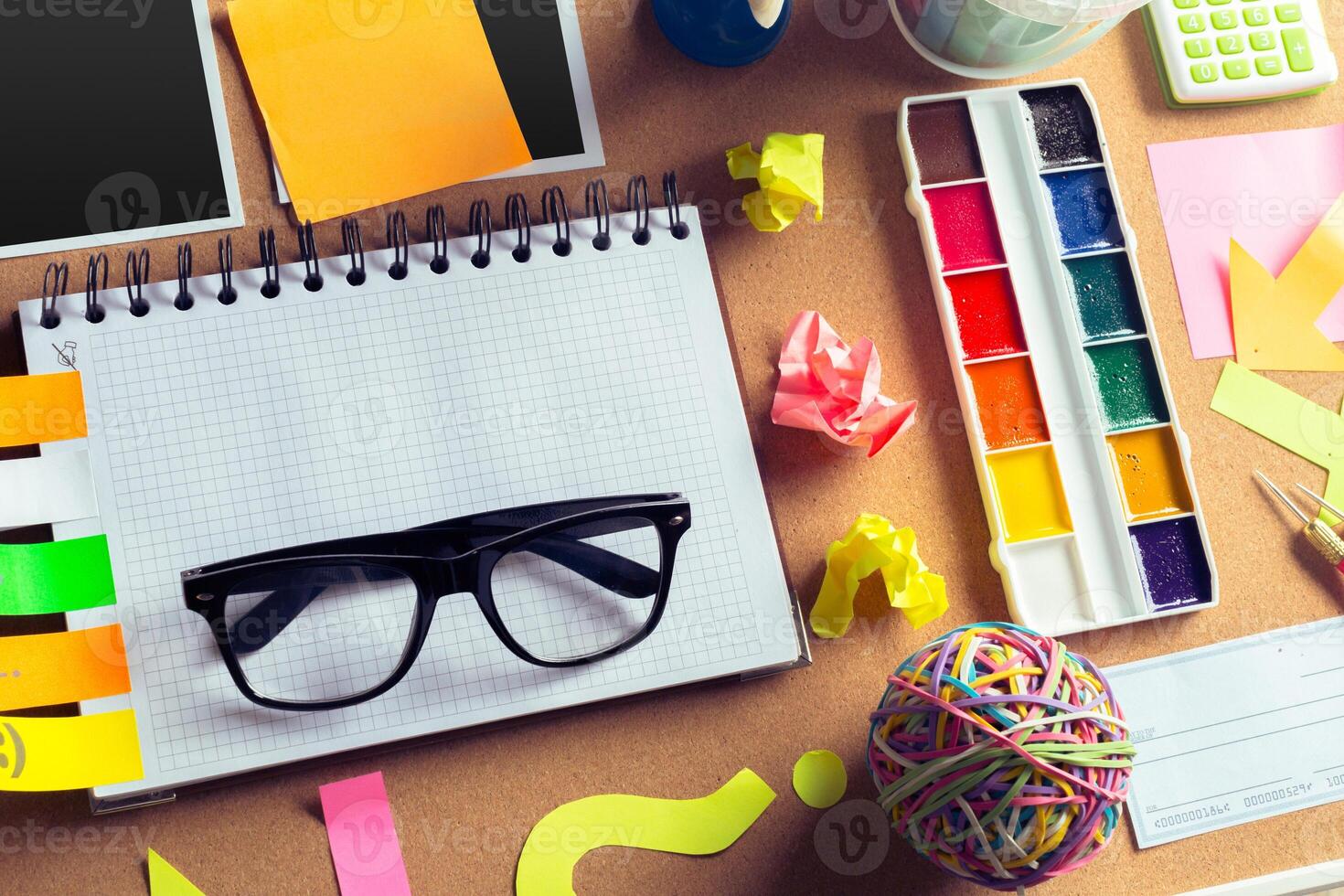 Desk of an artist with lots of stationery objects photo