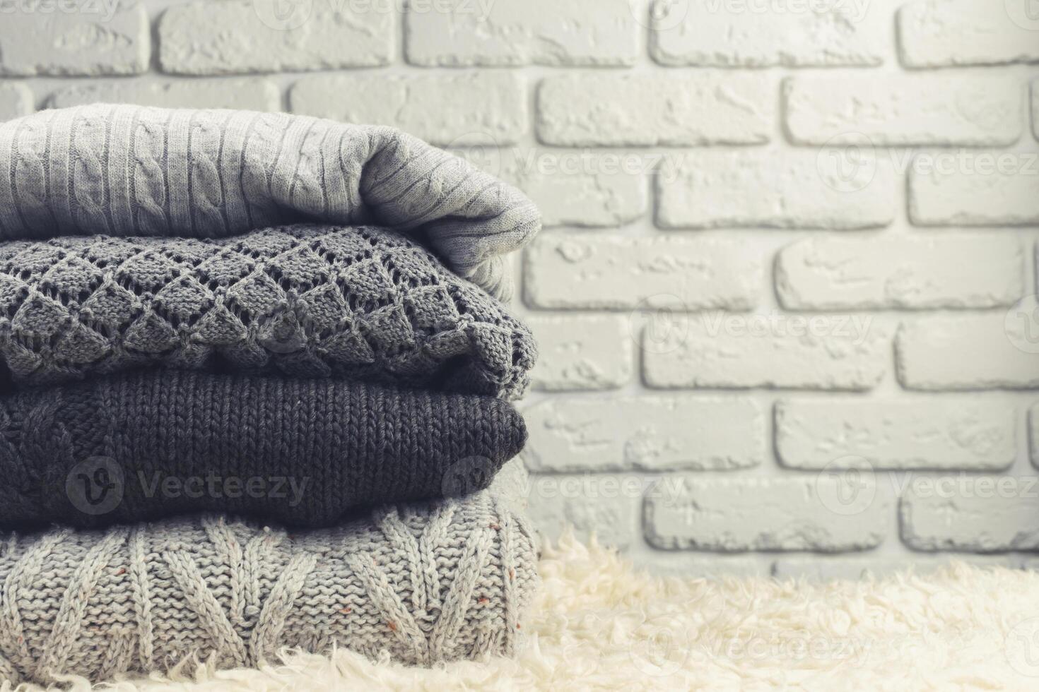 Stack of cozy knitted sweaters photo