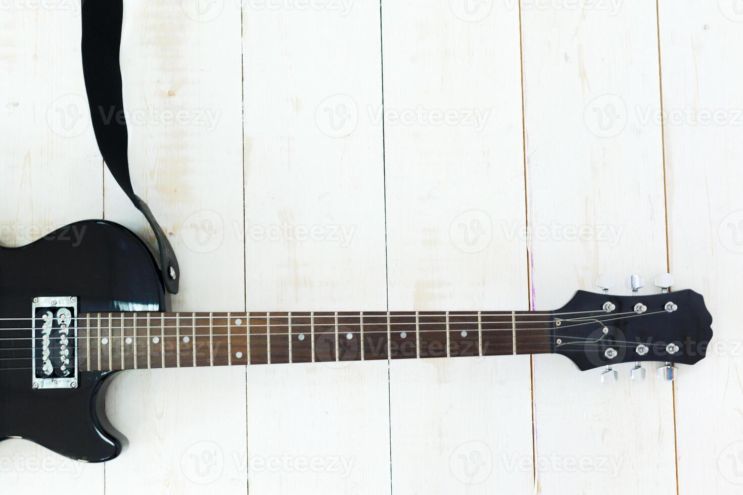 Electric guitar on old wooden surface photo
