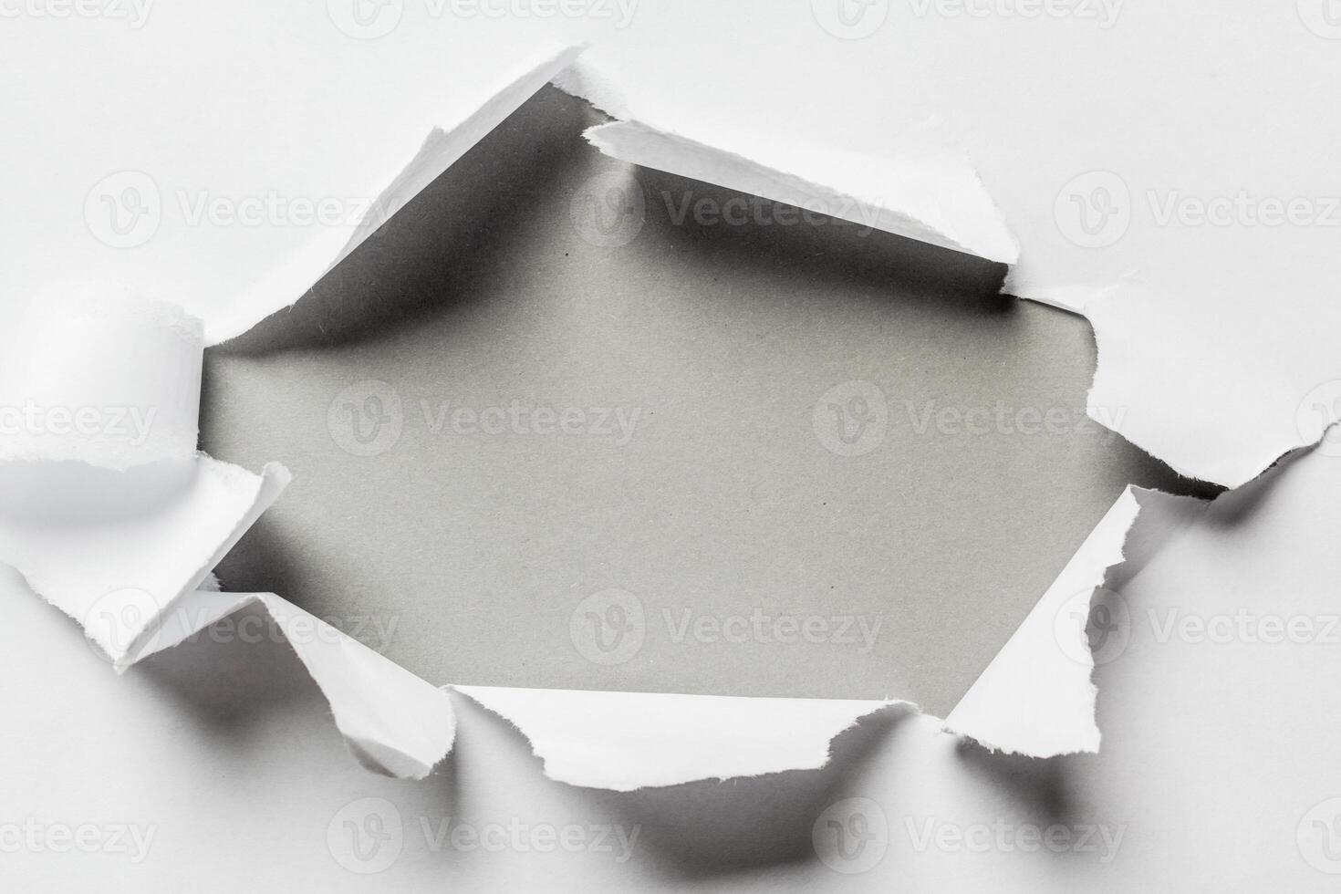 Hole in the paper with torn sides photo