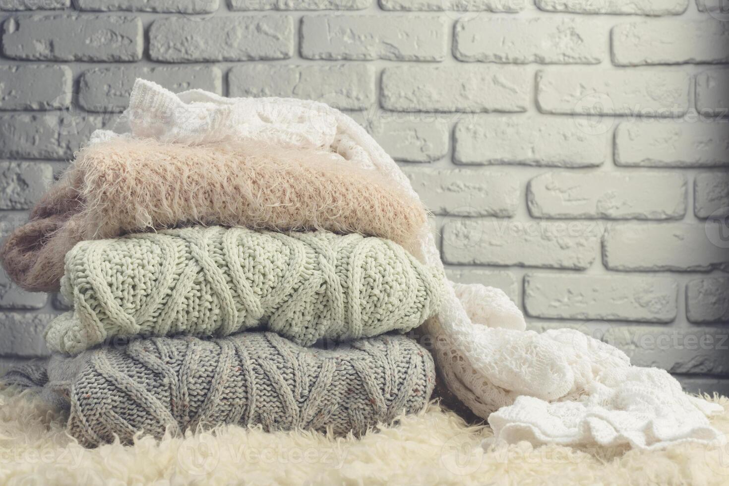Stack of cozy knitted sweaters photo
