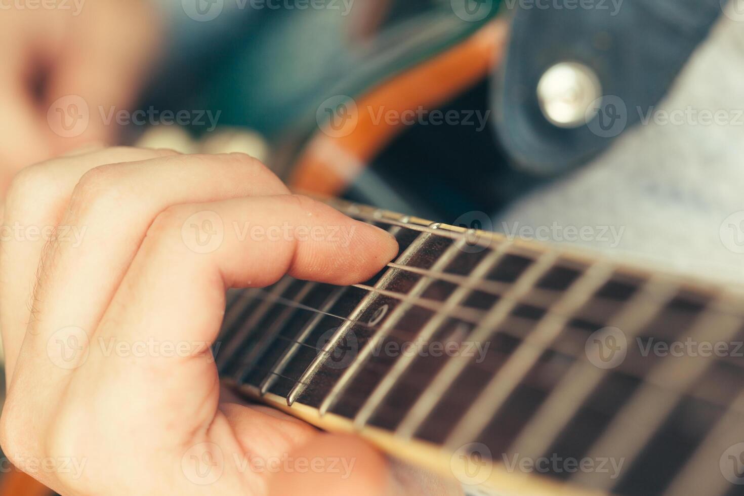 man playing electric guitar photo
