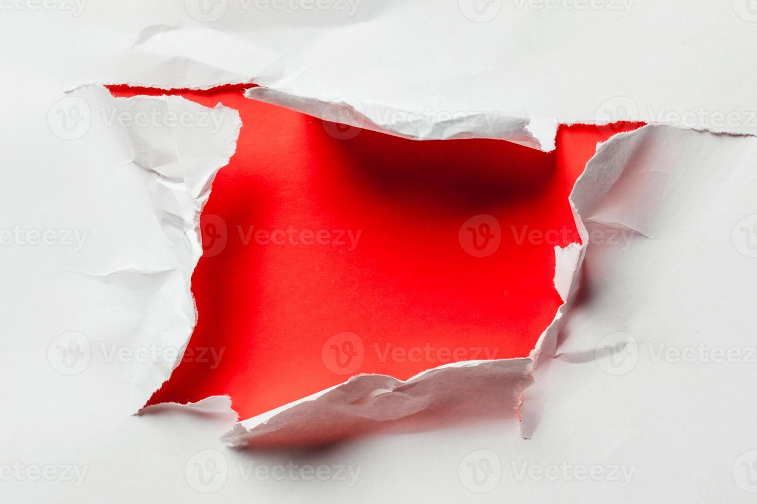 Hole in the paper with torn sides photo