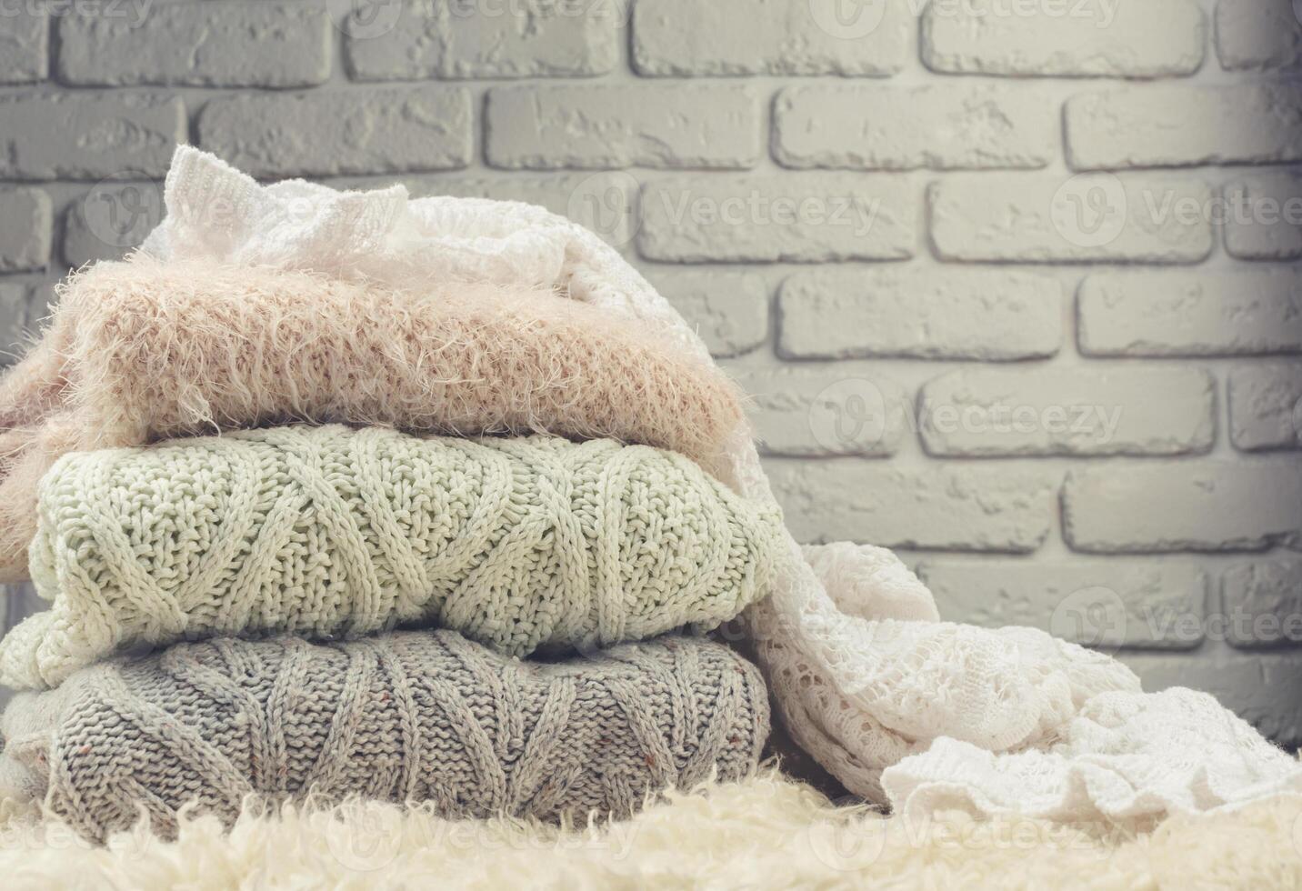 Stack of cozy knitted sweaters photo