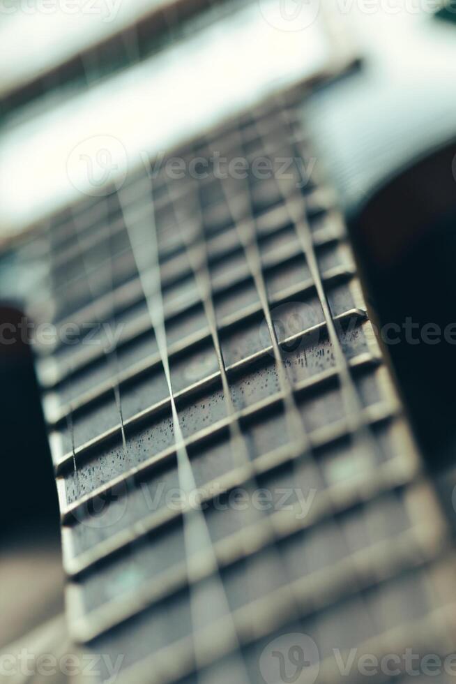Electric guitar body and neck detail on wooden background photo