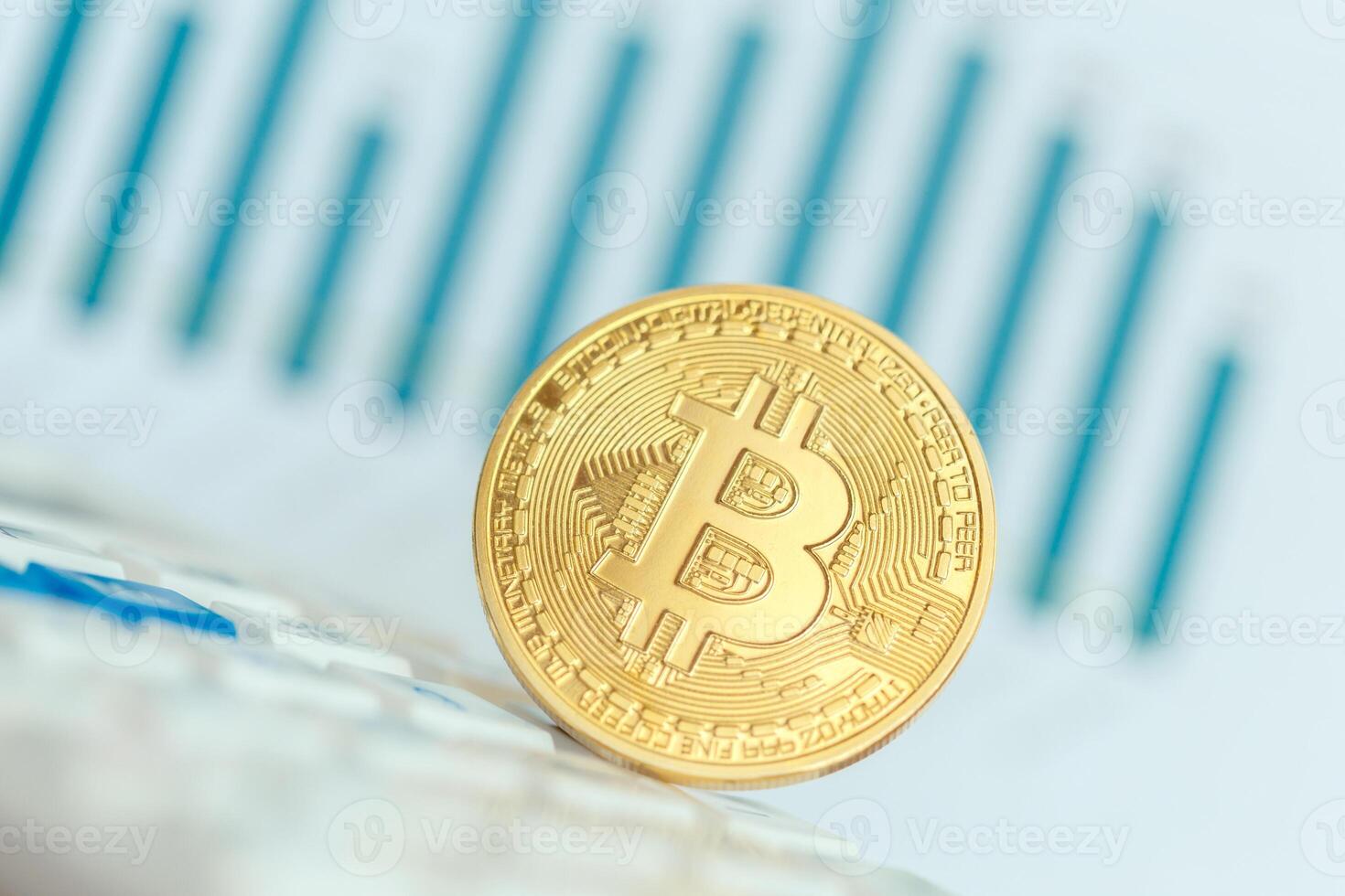 Golden bitcoin physical coin symbol on keyboard photo