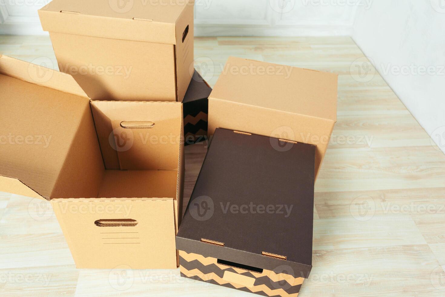 Big cardboard boxes standing insinde a room photo