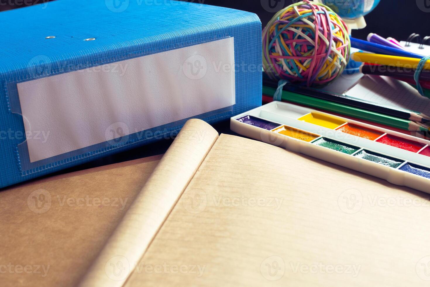 Desk of an artist with lots of stationery objects photo