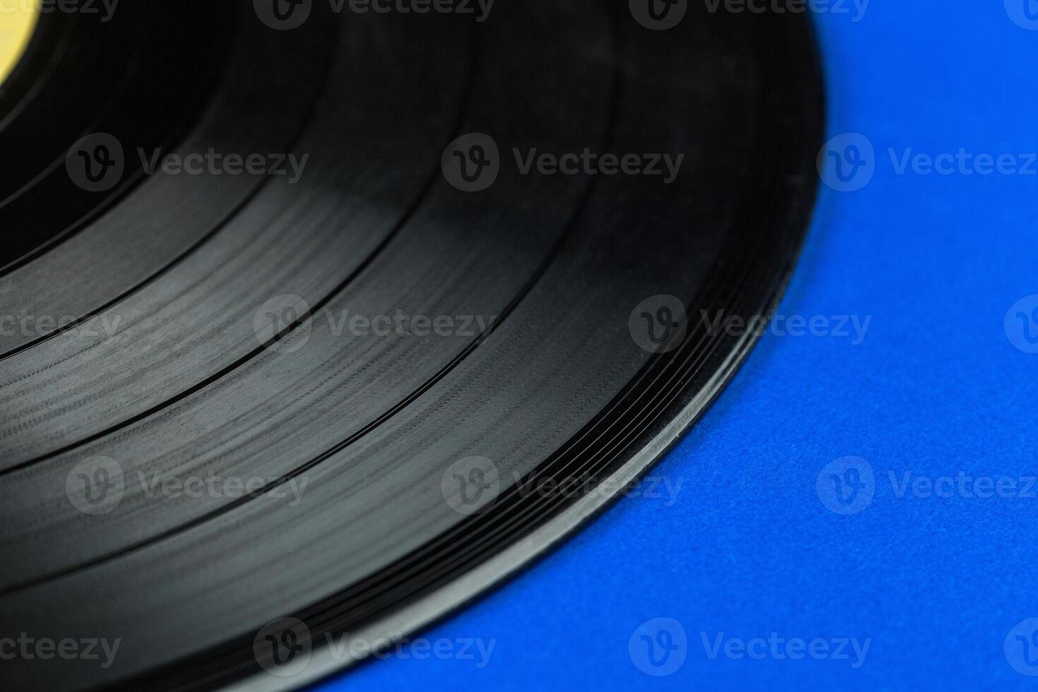 Retro vinyl record on blue background photo