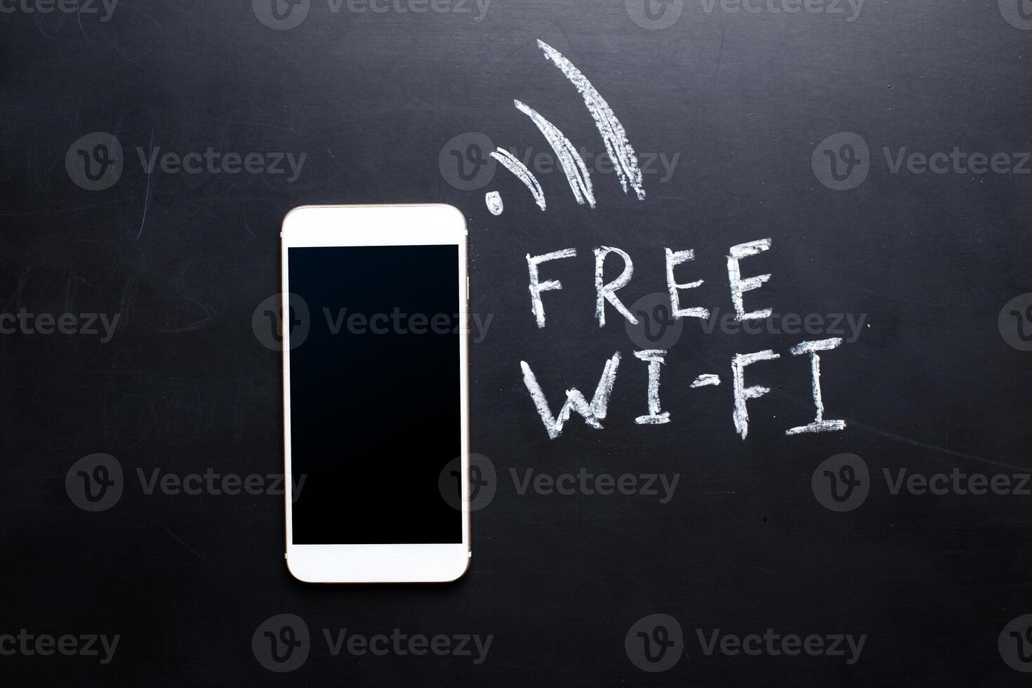 Wireless Symbol Drawn on a Blackboard near smartphone photo