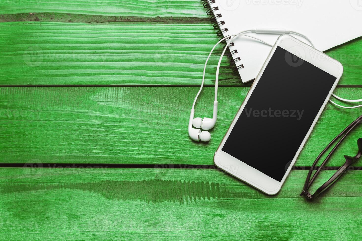 Office table with smartphone on it. View from above photo