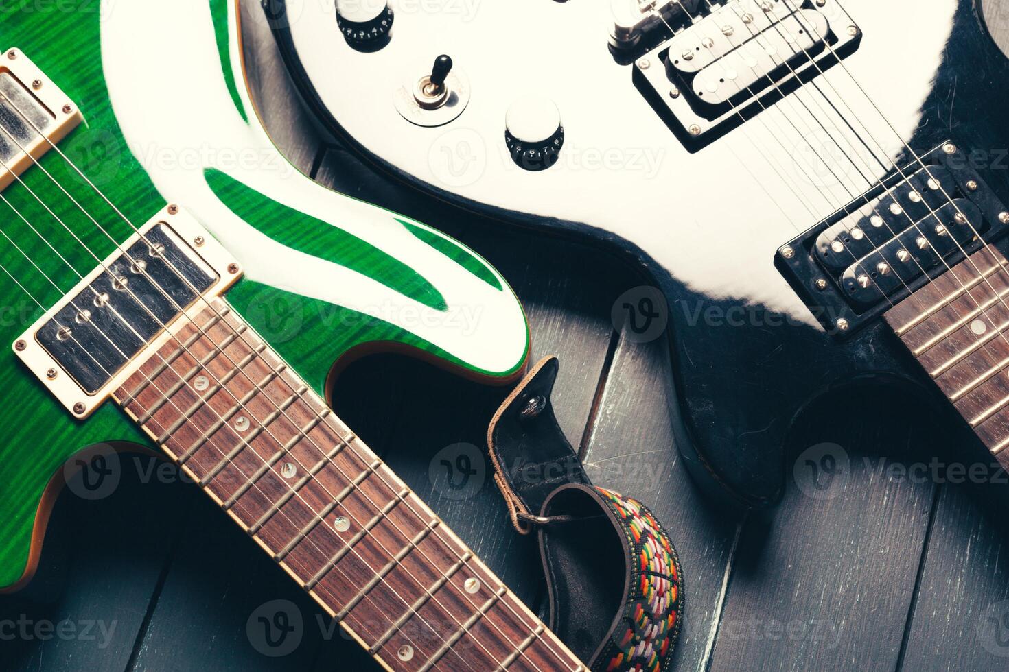 Electric guitar body and neck detail on wooden background photo