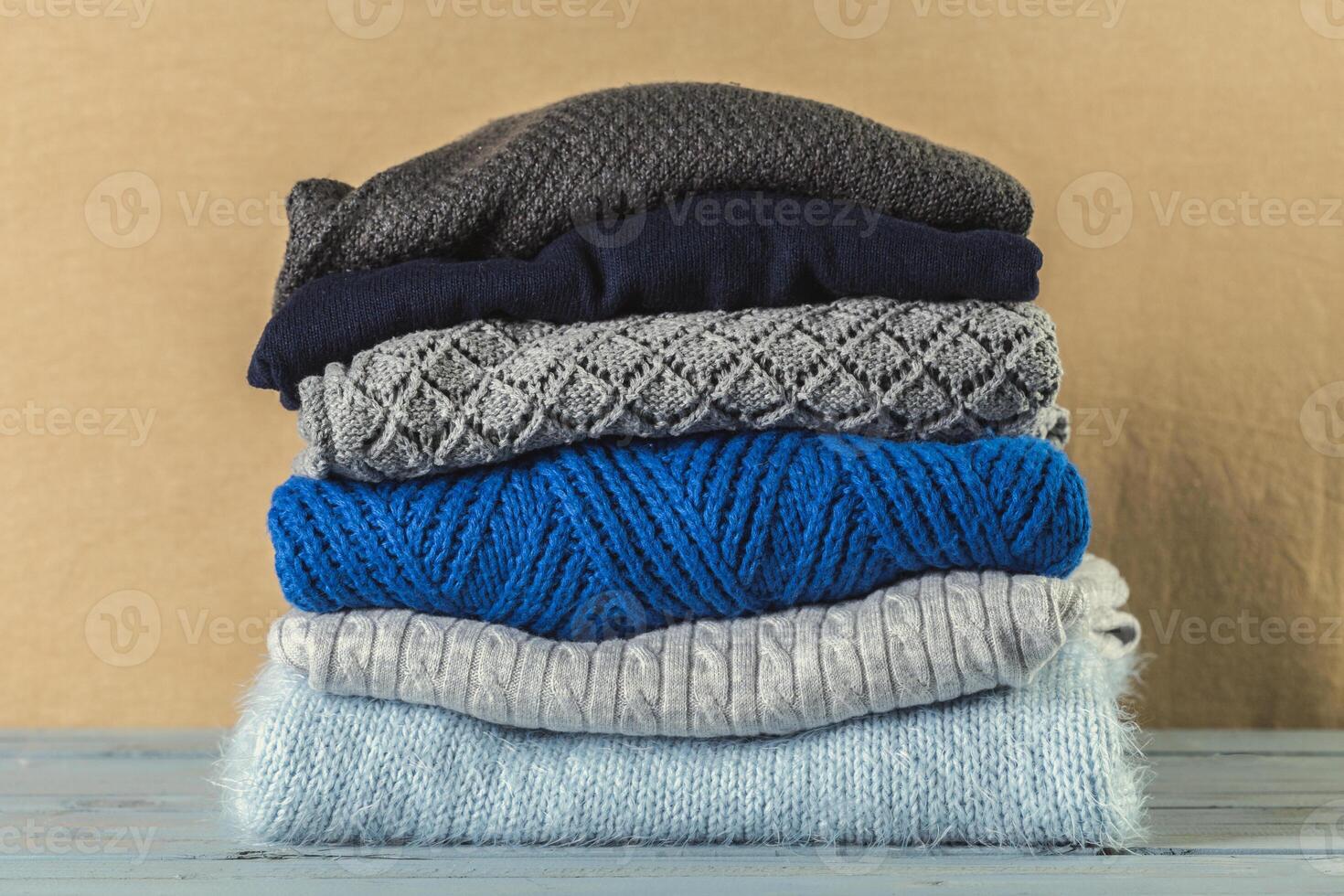 Stack of cozy knitted sweaters photo