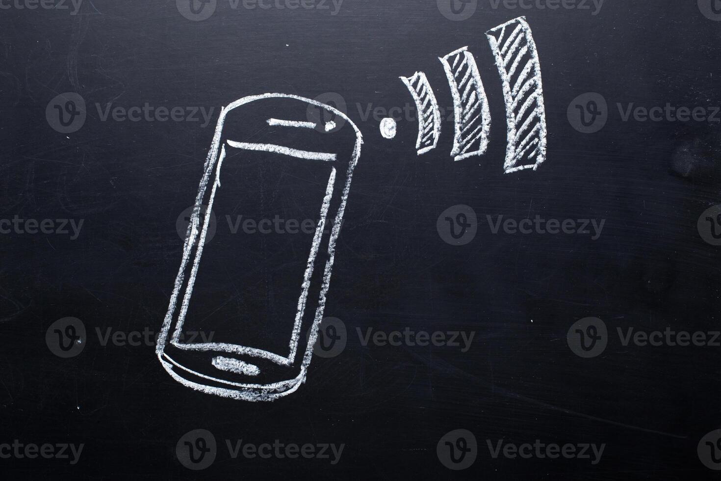 Wireless Symbol Drawn on a Blackboard near smartphone photo