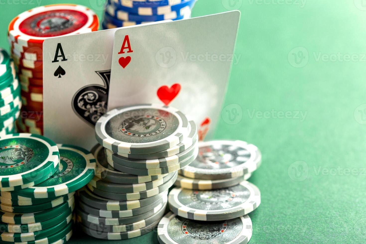 Cards and chips for poker on green table photo