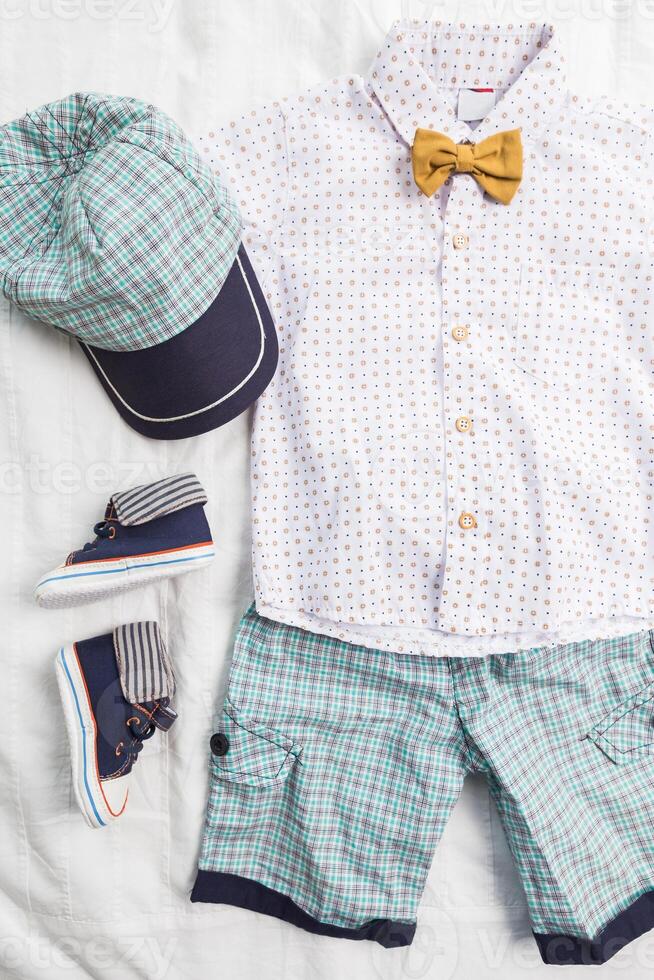 Baby boy clothes on white background photo