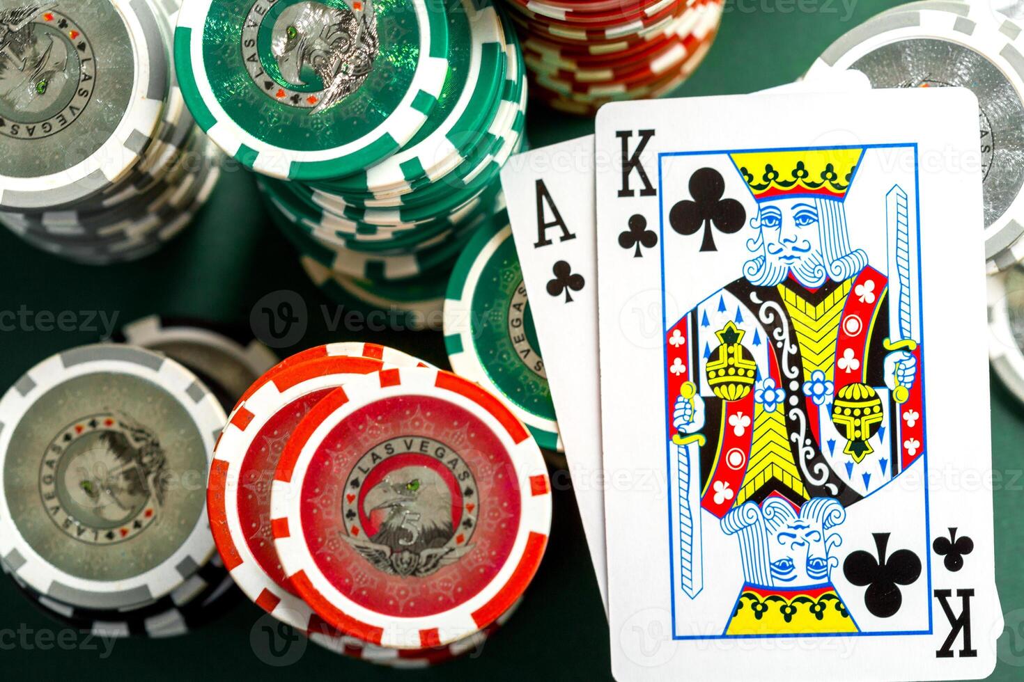 Cards and chips for poker on green table photo