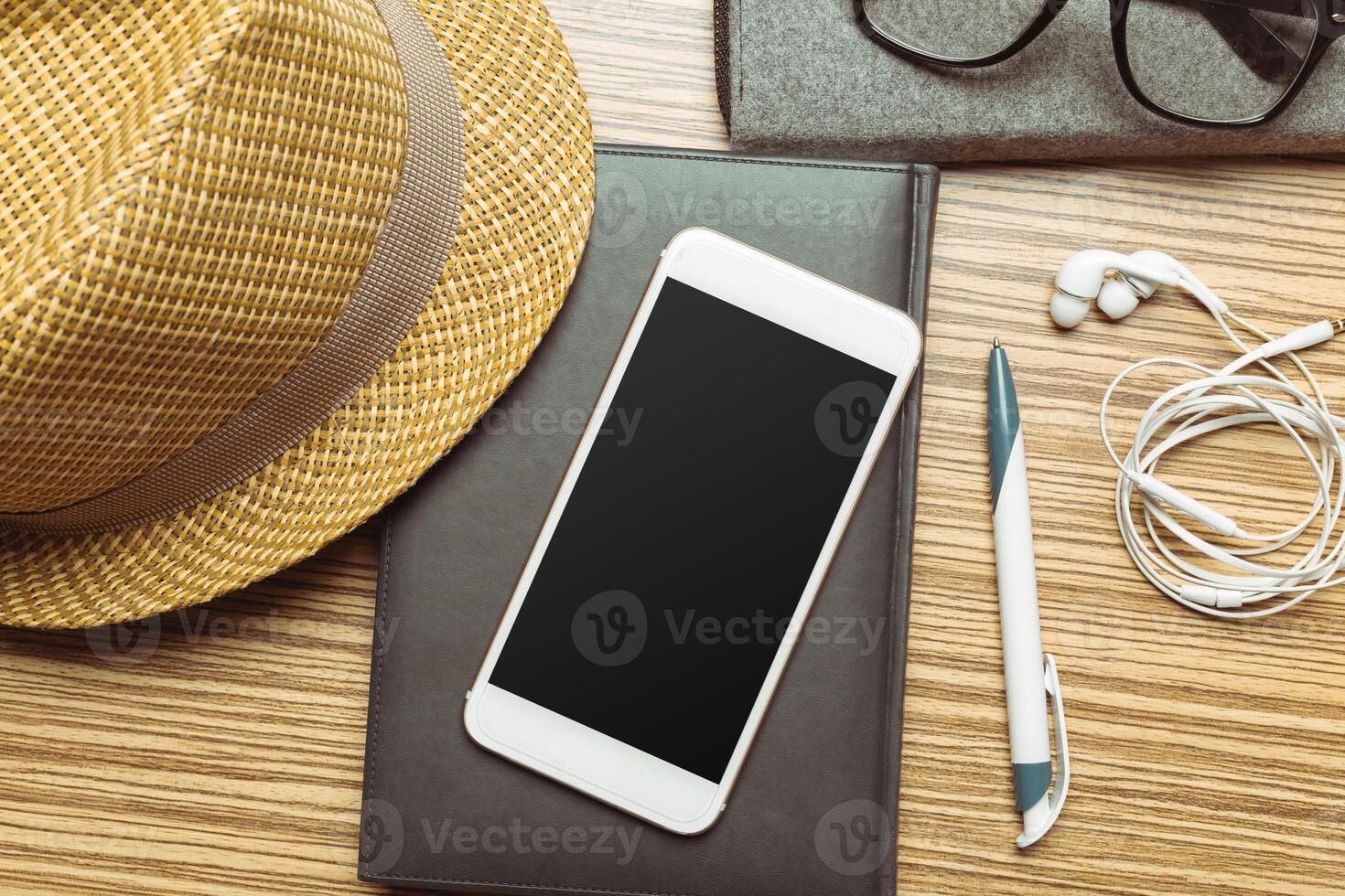 Office table with smartphone on it. View from above photo