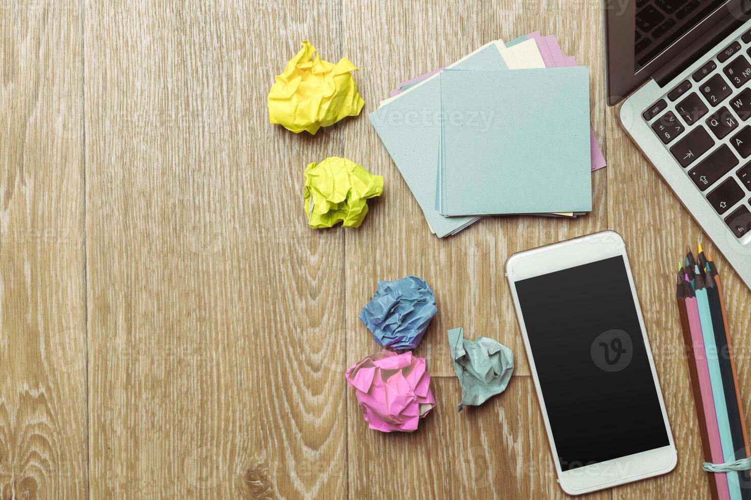 Office table with smartphone on it. View from above photo
