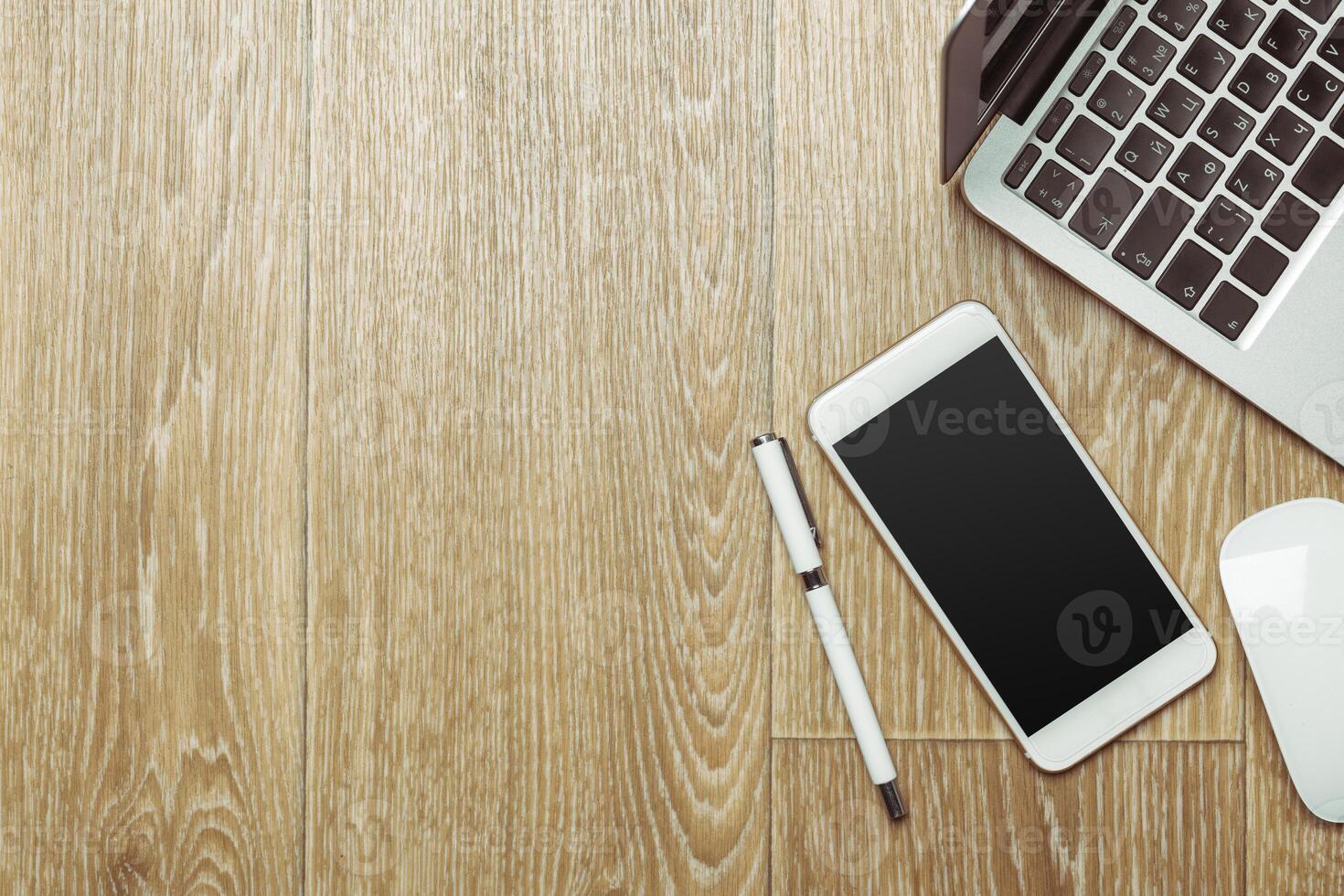 Office table with smartphone on it. View from above photo