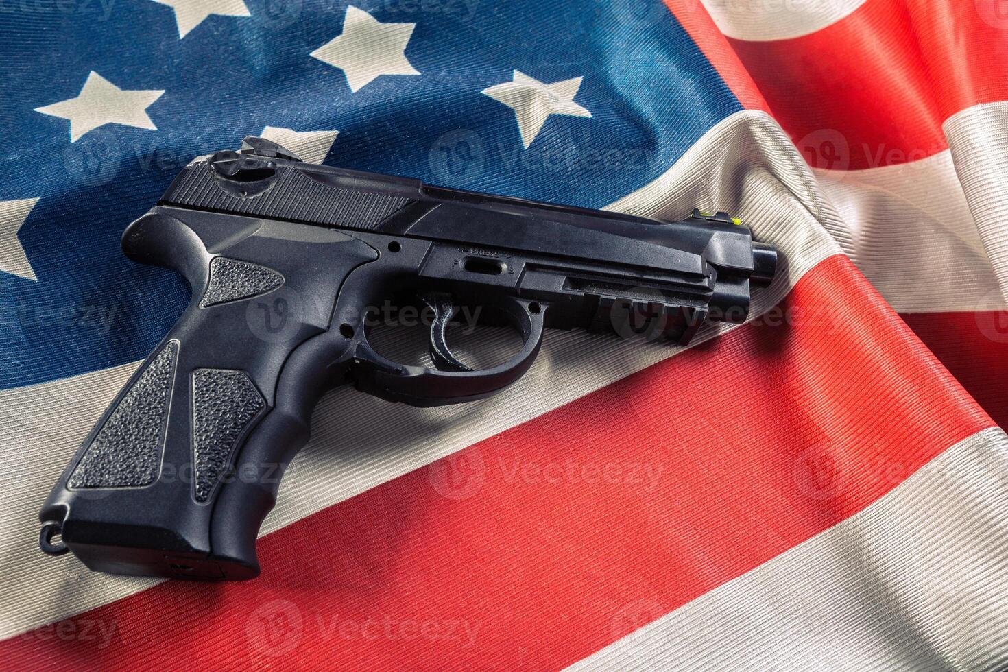 Handgun lying on American flag photo