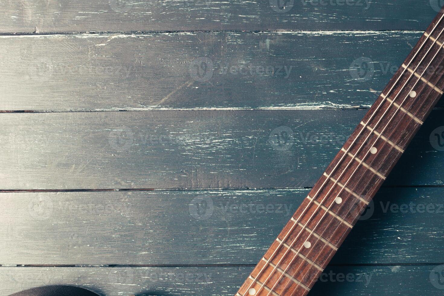 Electric guitar body and neck detail on wooden background photo