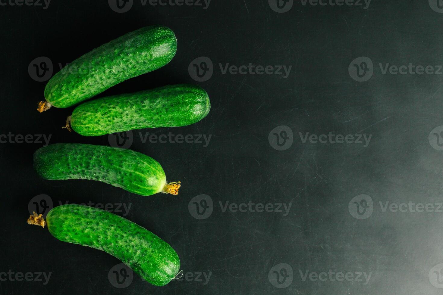 Fresh cucumber on black background photo