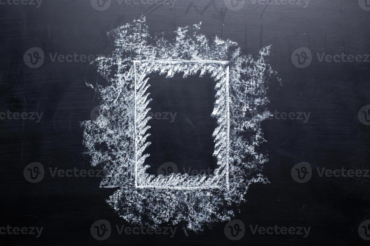 Hand drawing chalk frame on blackboard photo