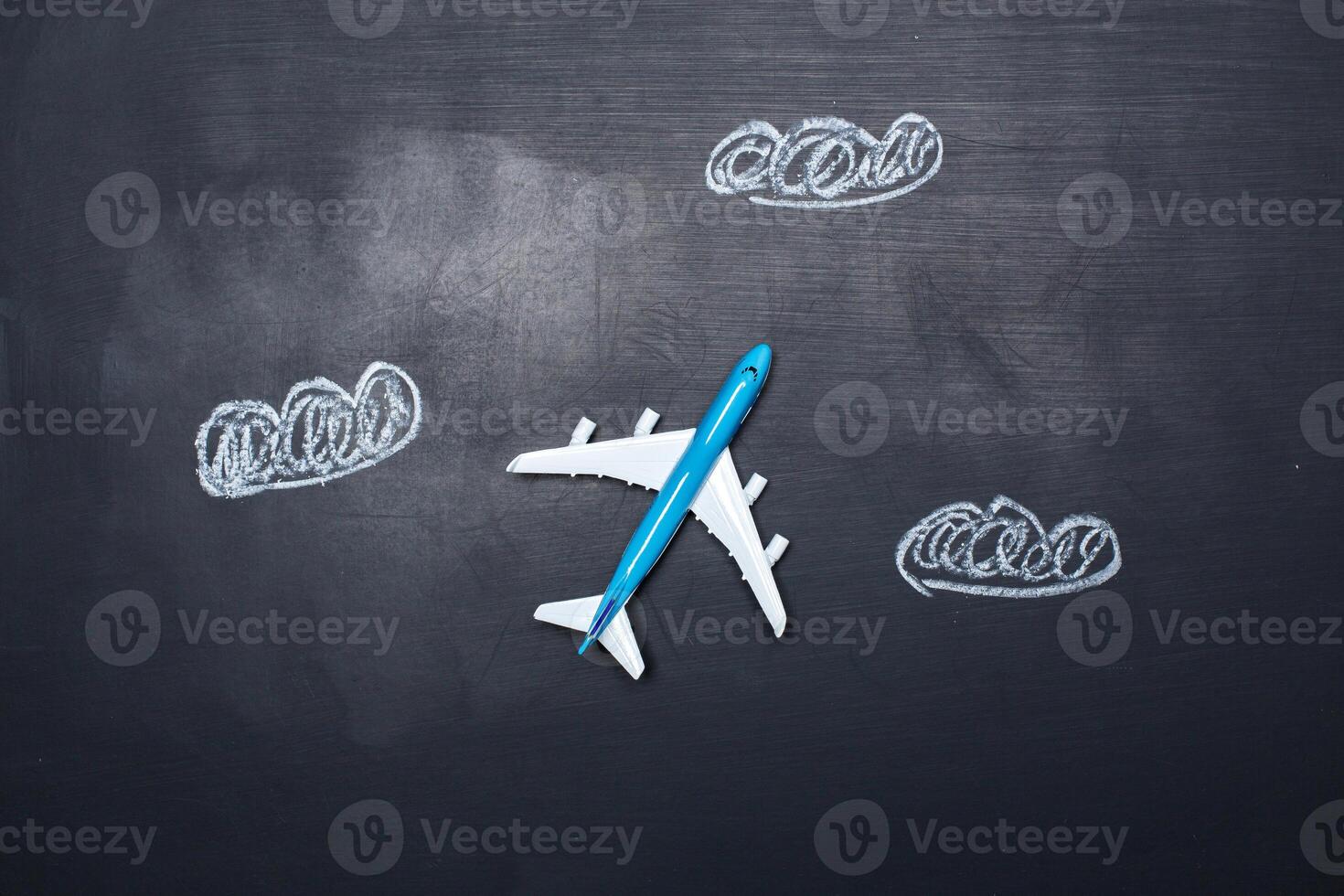 toy airplane over chalkboard background and arrows drawings photo
