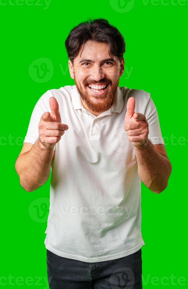 Smiling man gestures playfully with finger guns against a vibrant green background photo