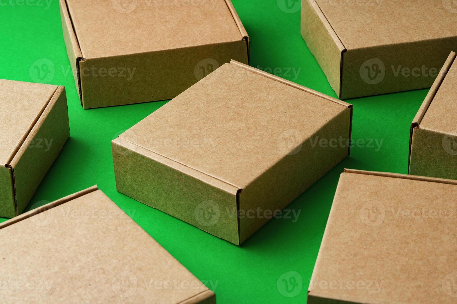 Brown cardboard boxes arranged on a vibrant green surface photo
