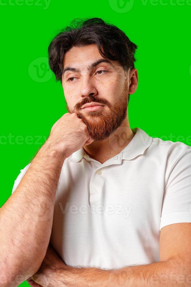 A man with a serious expression stands against a vibrant green background photo