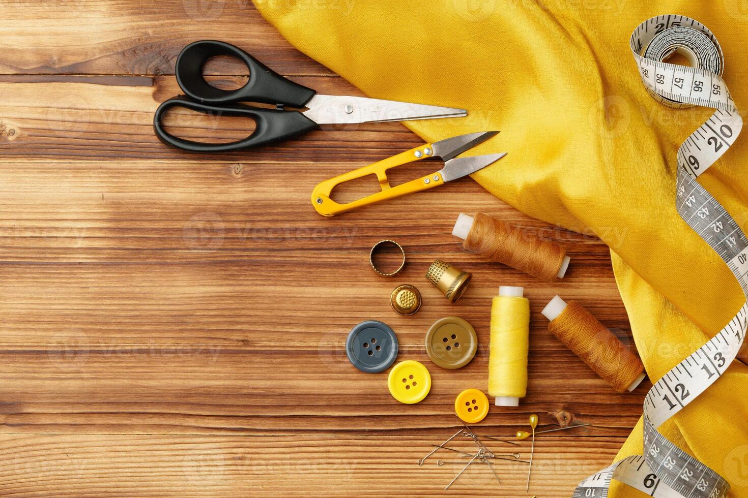 Crafting tools and materials arranged on a wooden table for sewing projects photo