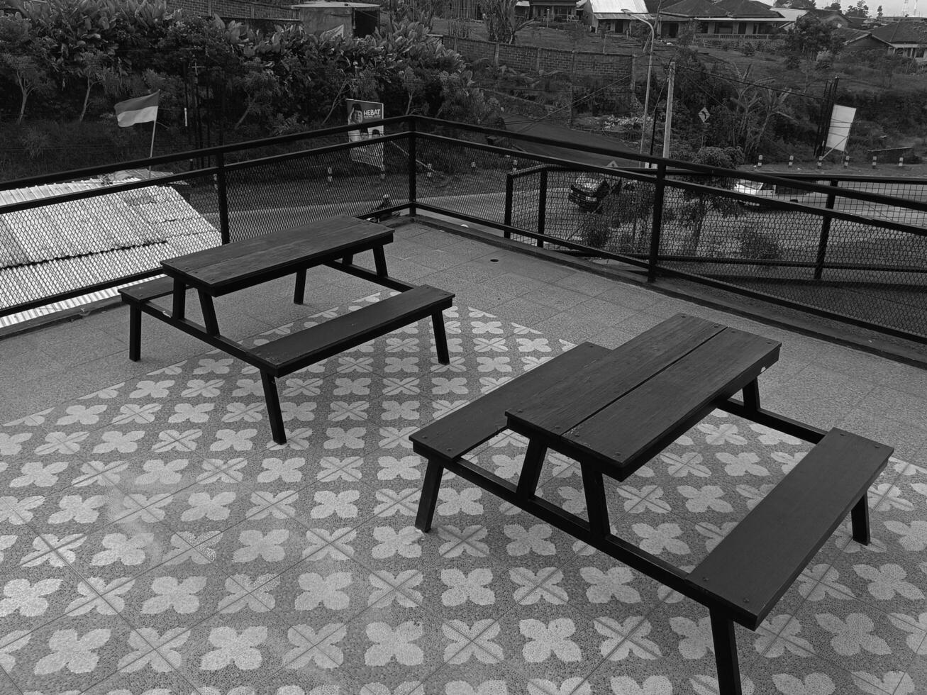 Rooftop Picnic Benches with a Scenic Village Backdrop for Relaxation photo