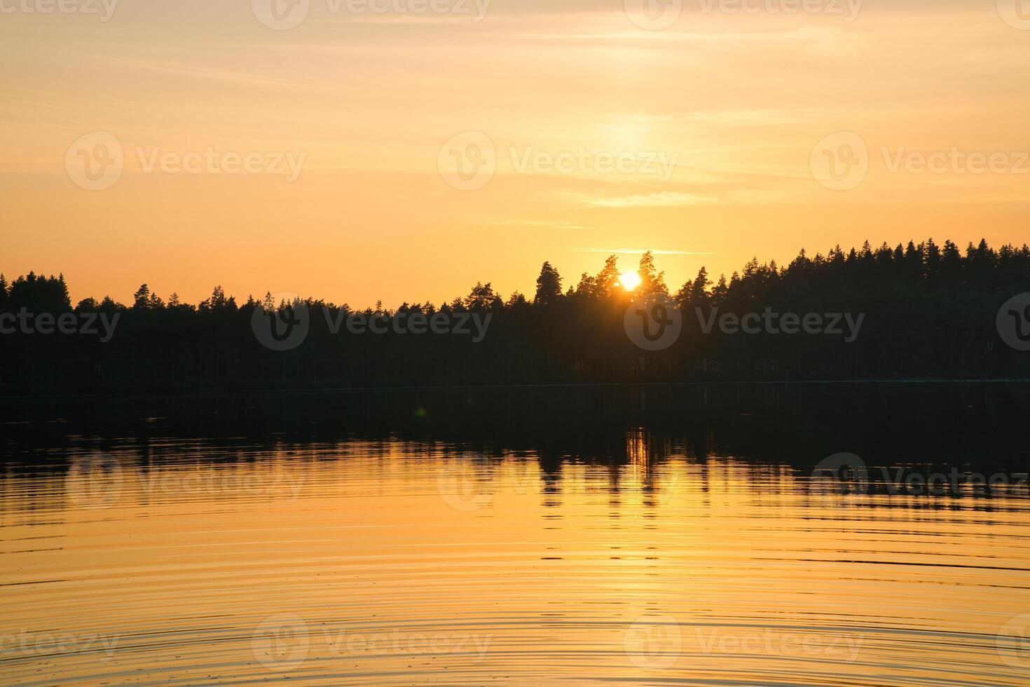 Sunset with warm colors on a Swedish lake in Smalland. Romantic evening atmosphere photo