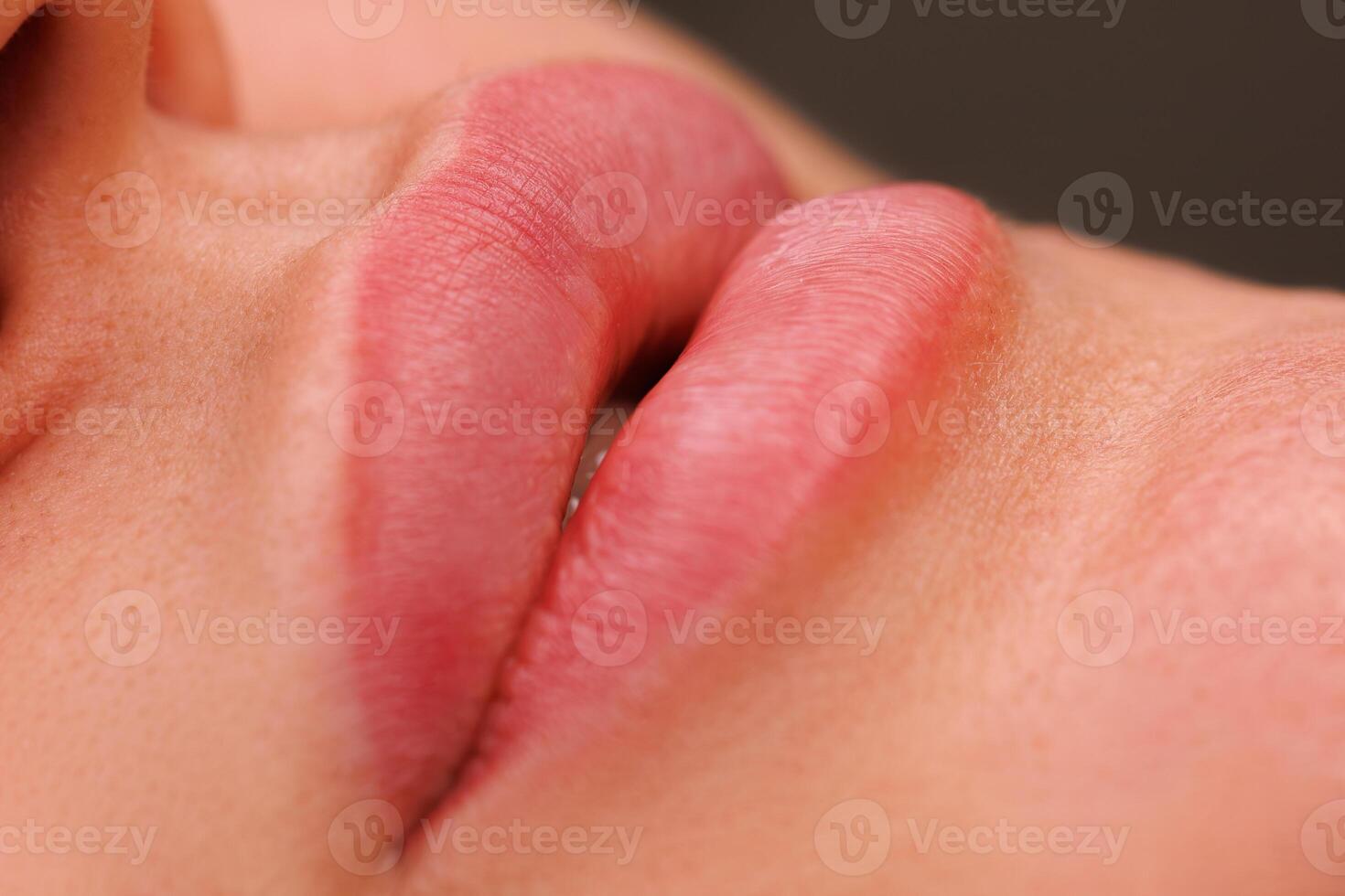 A close up of lips one month after tattooing. The soft pigment enhances their shape and gives a natural look after healing. photo
