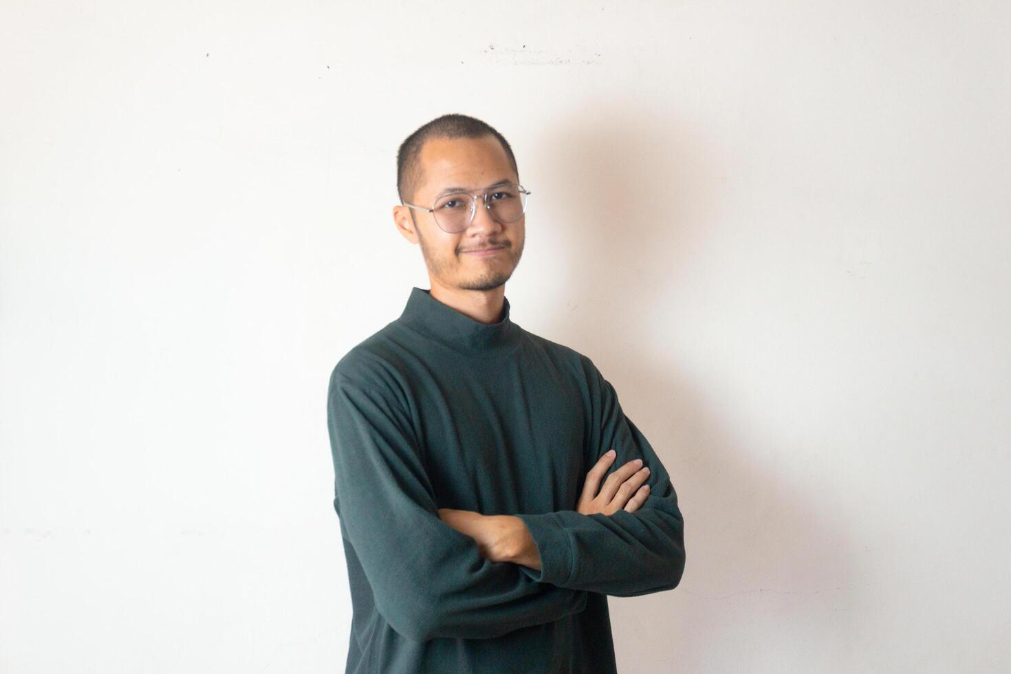 Young men wearing sweater and eye glasses crossed arm smiling on isolated white background photo