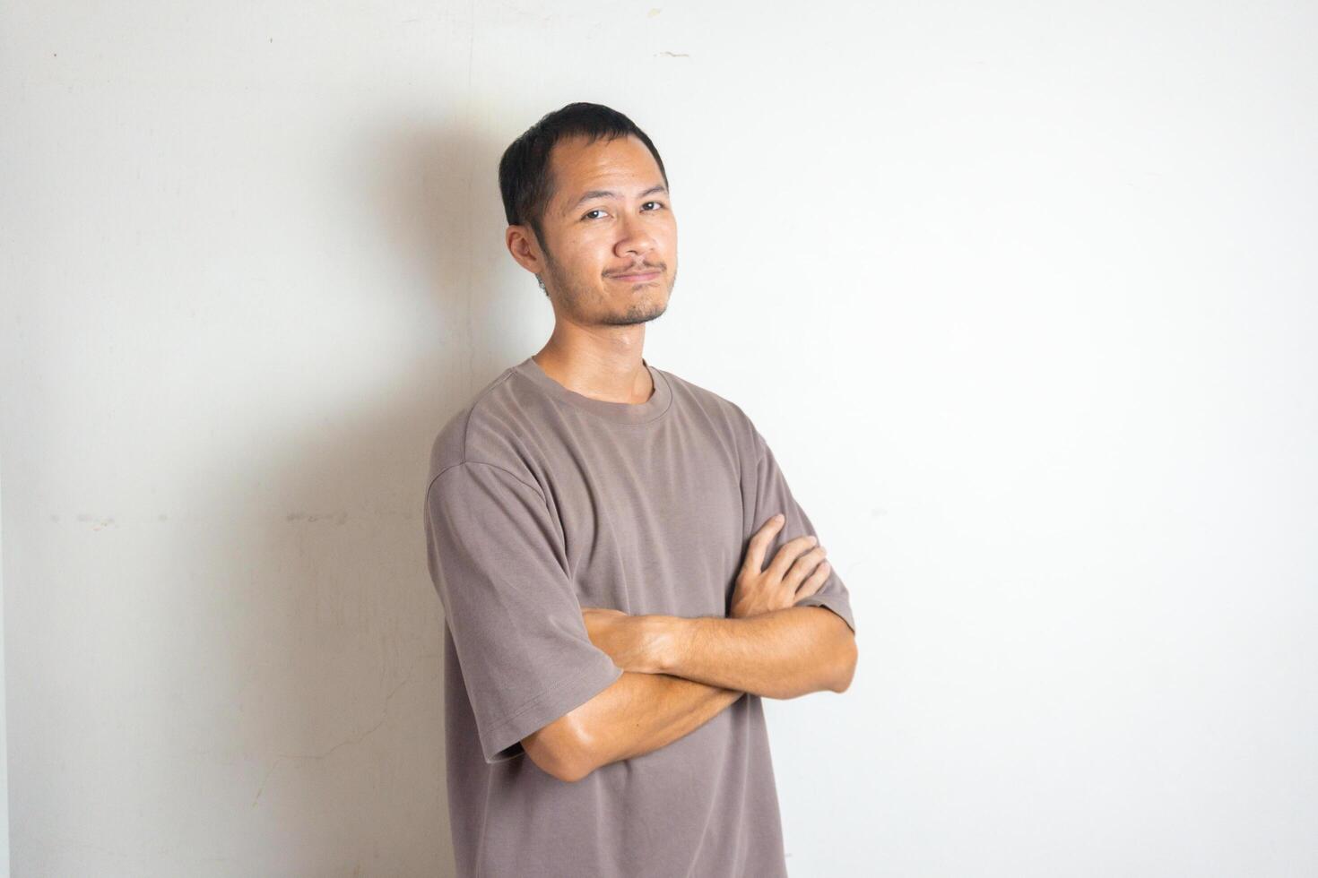 young men wearing shirt crossed his arm with smile on isolated white background photo