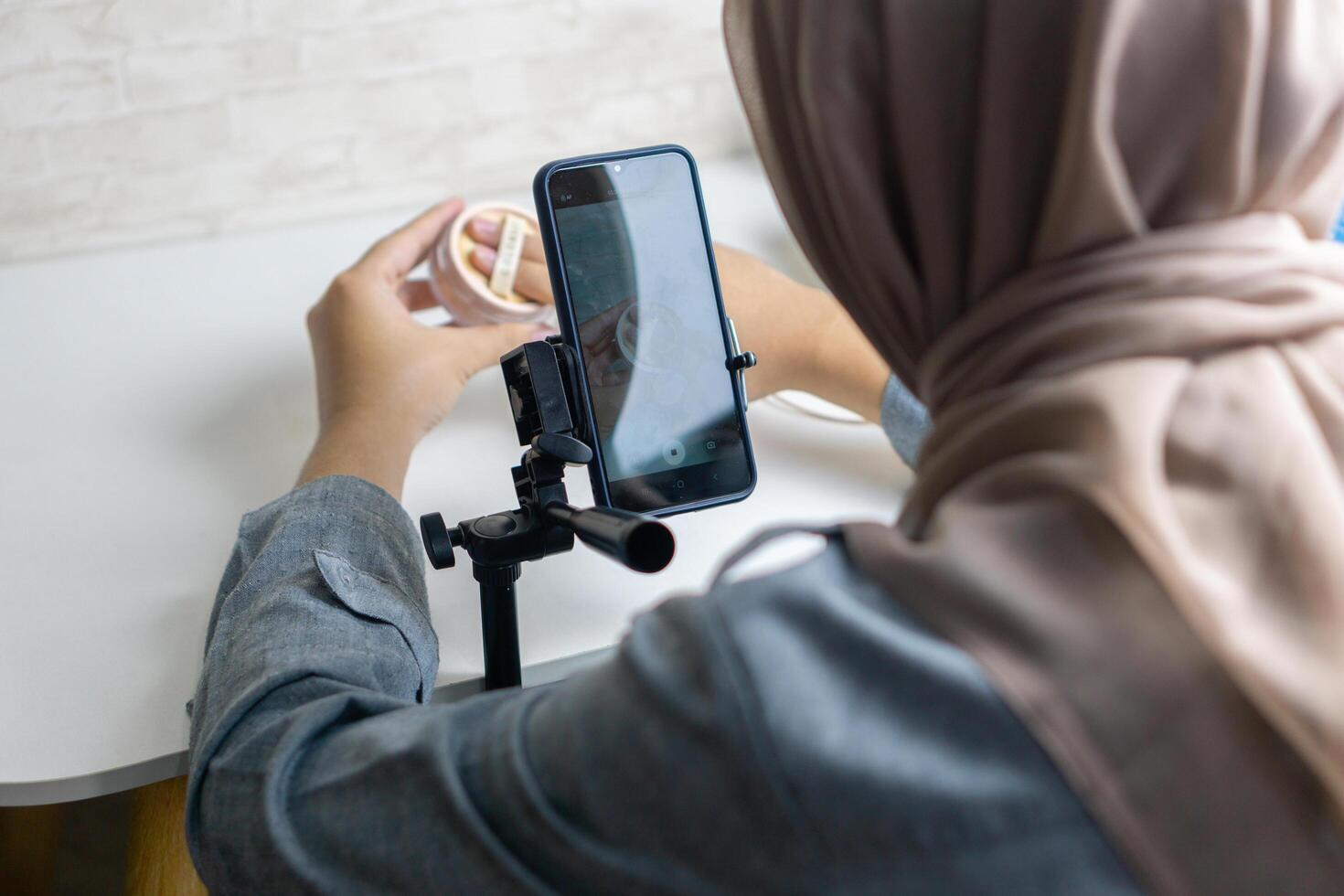 Woman with hijab preparing the recording mobile phone to make a and produce content photo