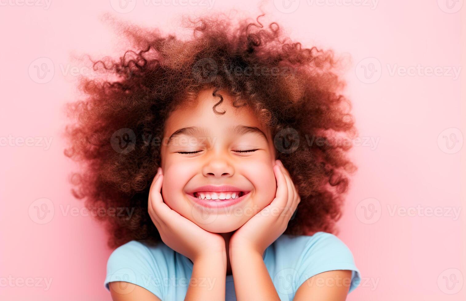 A little girl with curly hair smiling photo