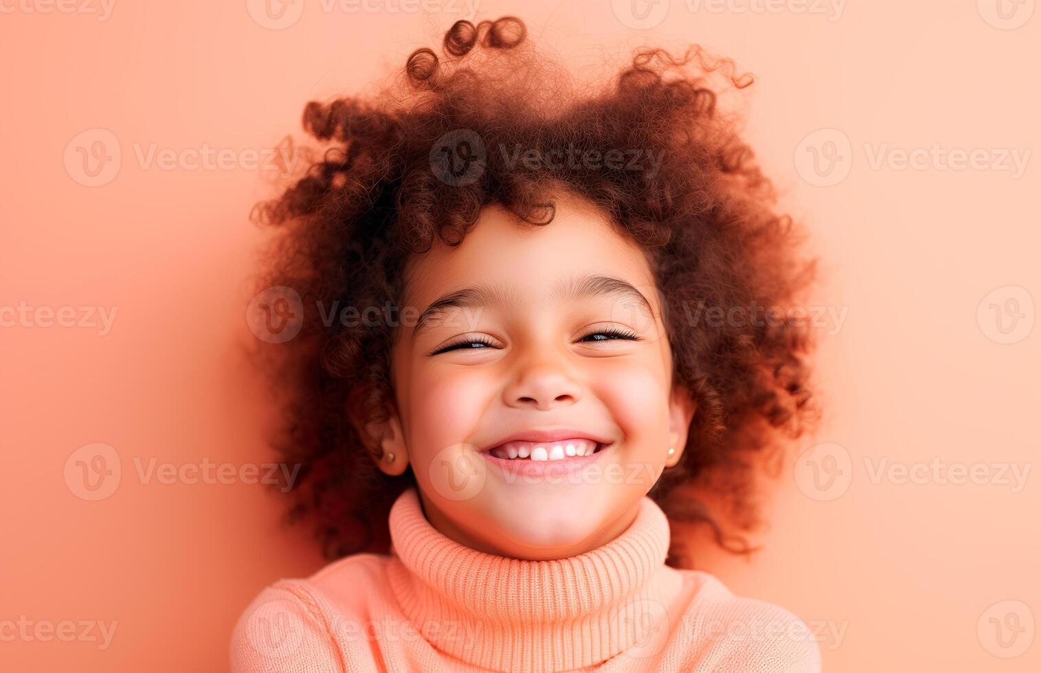 A little girl with curly hair smiling photo