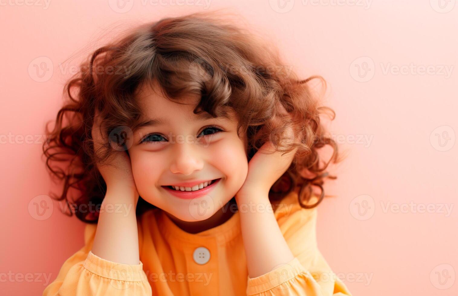 A little girl with curly hair is smiling photo