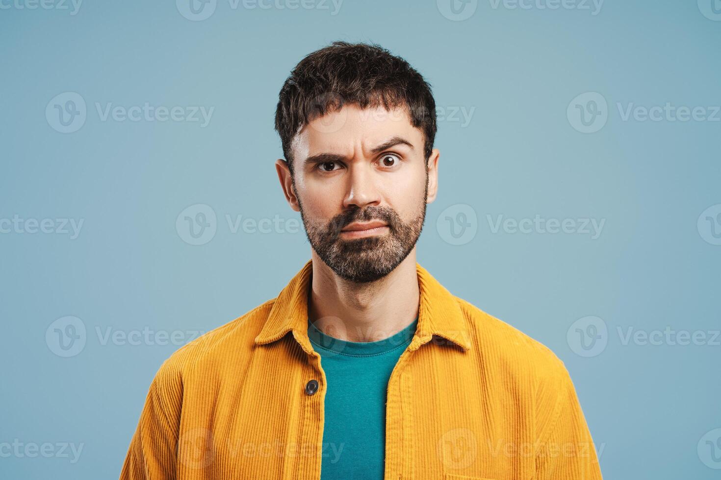 Shocked, amazed, beaded man wearing stylish yellow shirt, looking at camera photo